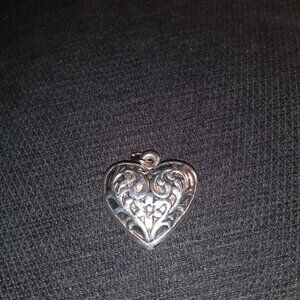 Silver tone heart shaped metal pendant.